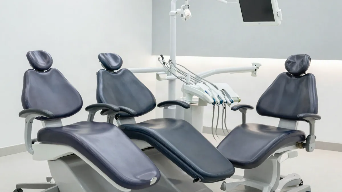 Three modern dental patient chairs in a dental equipment showroom